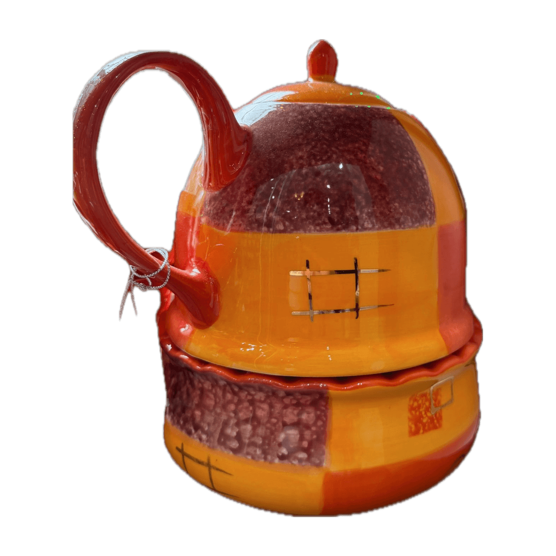 Kombination aus kleiner Kanne und Tasse in Orange- und Rottönen mit Karomuster.
