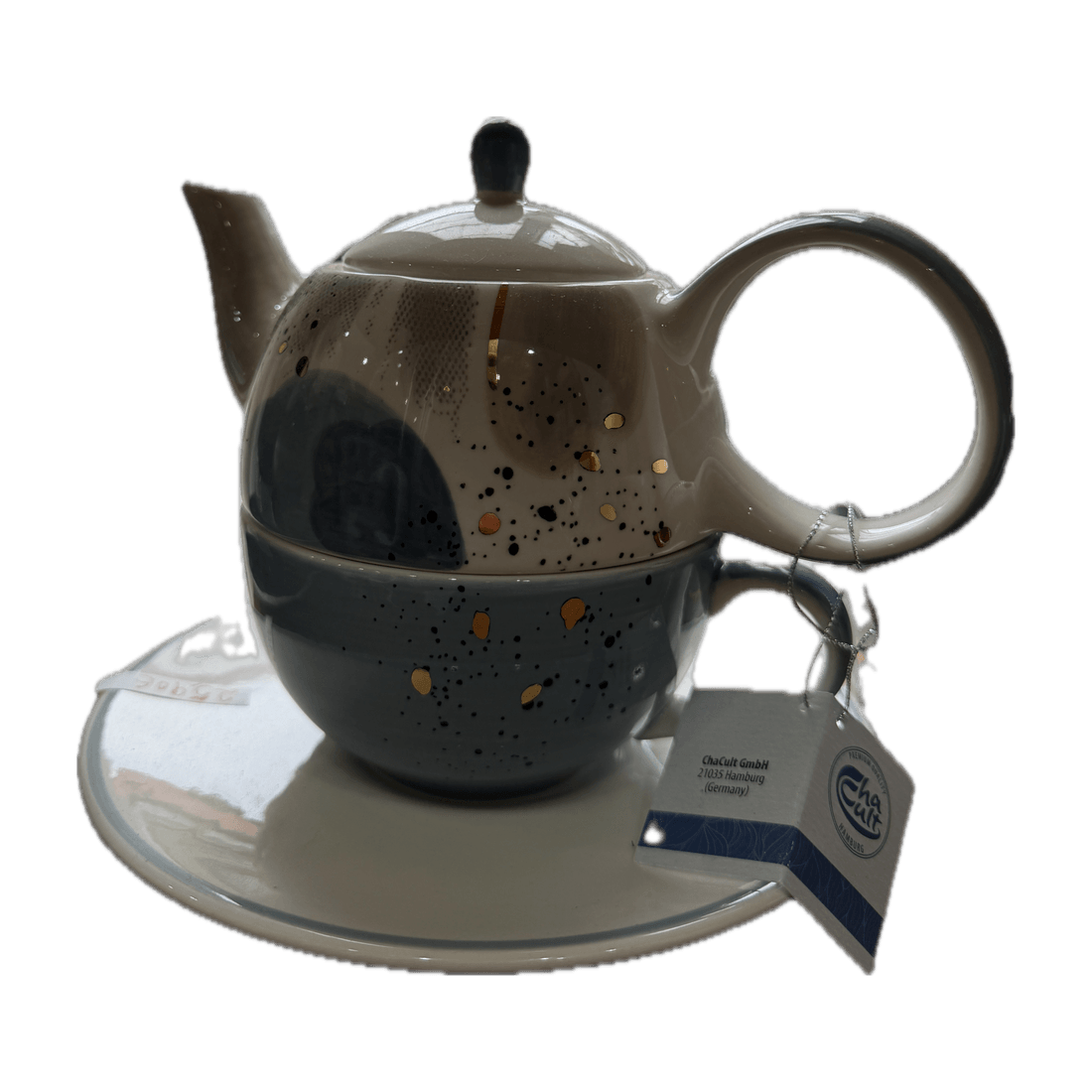 Graues Set aus Kanne und Tasse mit goldenen Punkten.